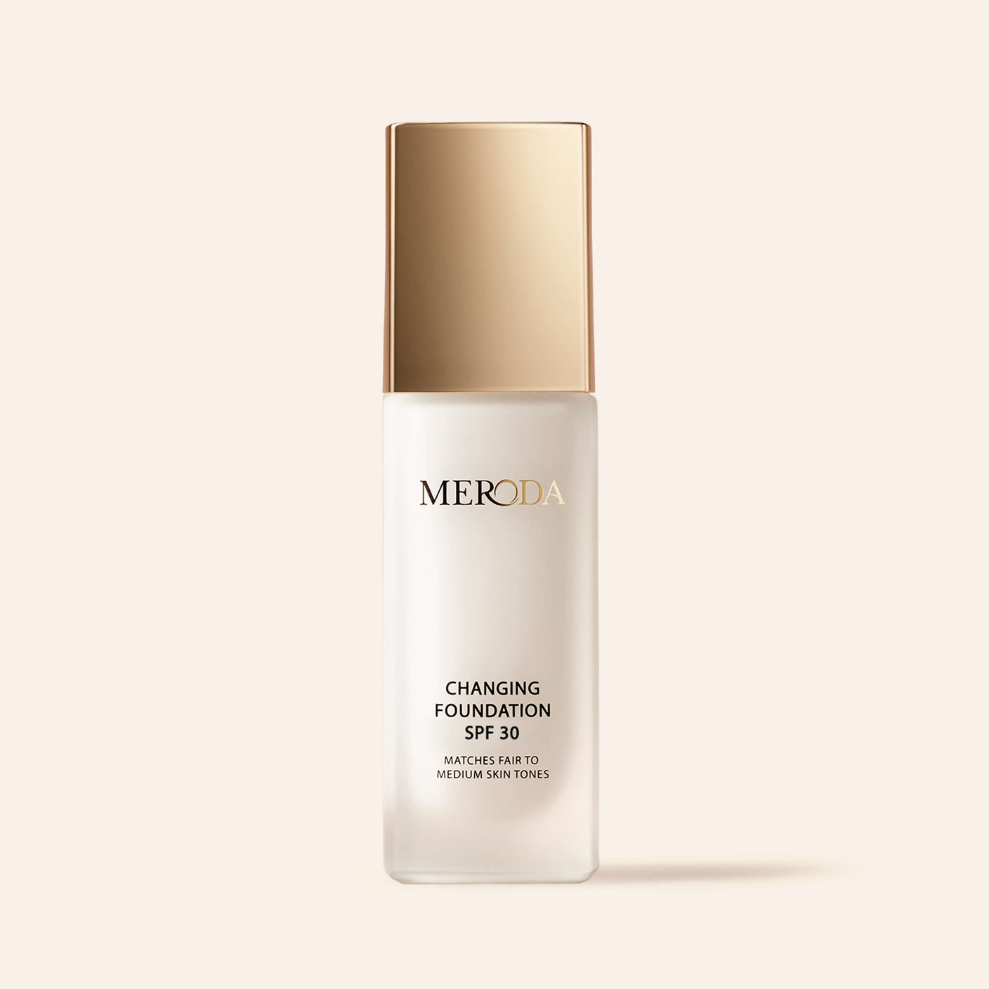 Meroda Changing Foundation SPF 30 in a frosted bottle with a gold cap for fair to medium skin tones.