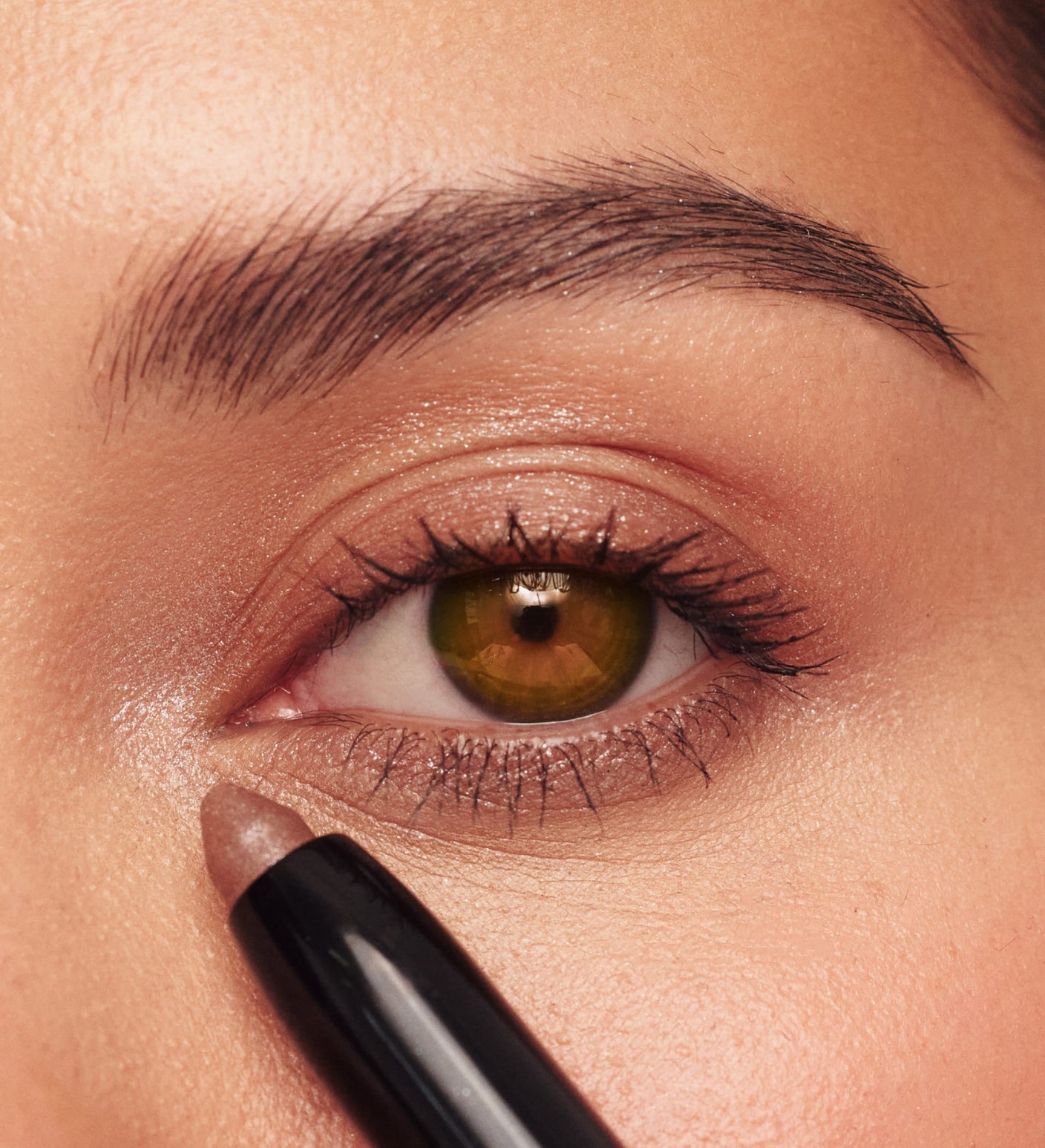 Eye Perfecting Shimmer Stick in Bronze from The Summer Set applied to the eye for a glowing finish.