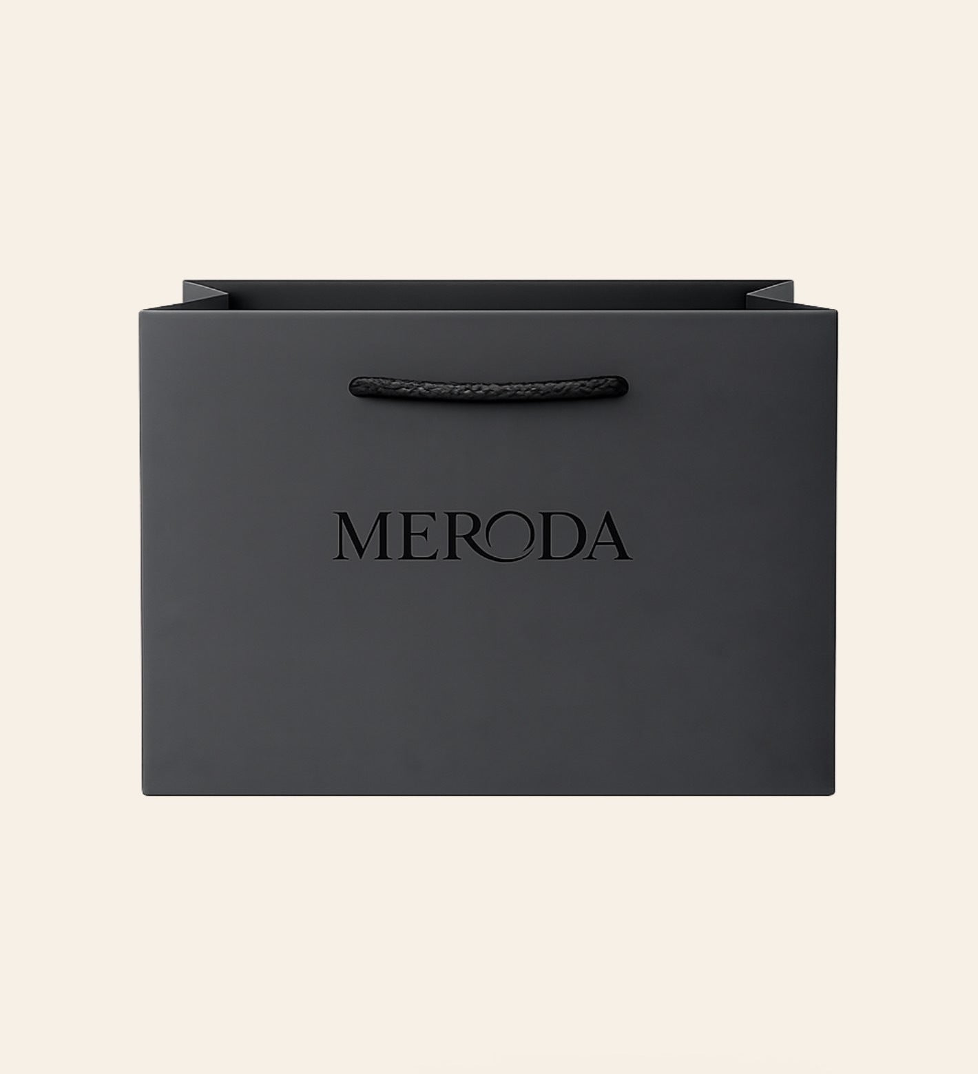 Gift Bag in matte black featuring a woven rope handle and embossed Meroda logo on a cream background.
