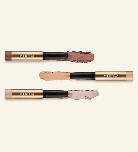 Mini Eye Shimmer Set featuring three gold Eye Perfecting Shimmer Sticks with creamy texture swatches in shimmering shades.