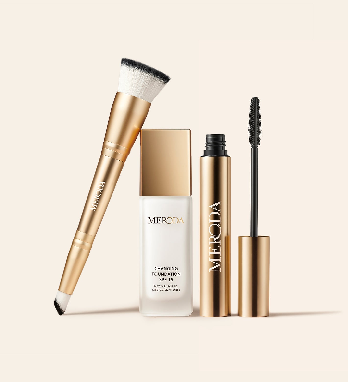 The Effortless Edit bundle with Changing Foundation, Gilded Lashes Mascara and 2-in-1 Build & Conceal Brush in gold.