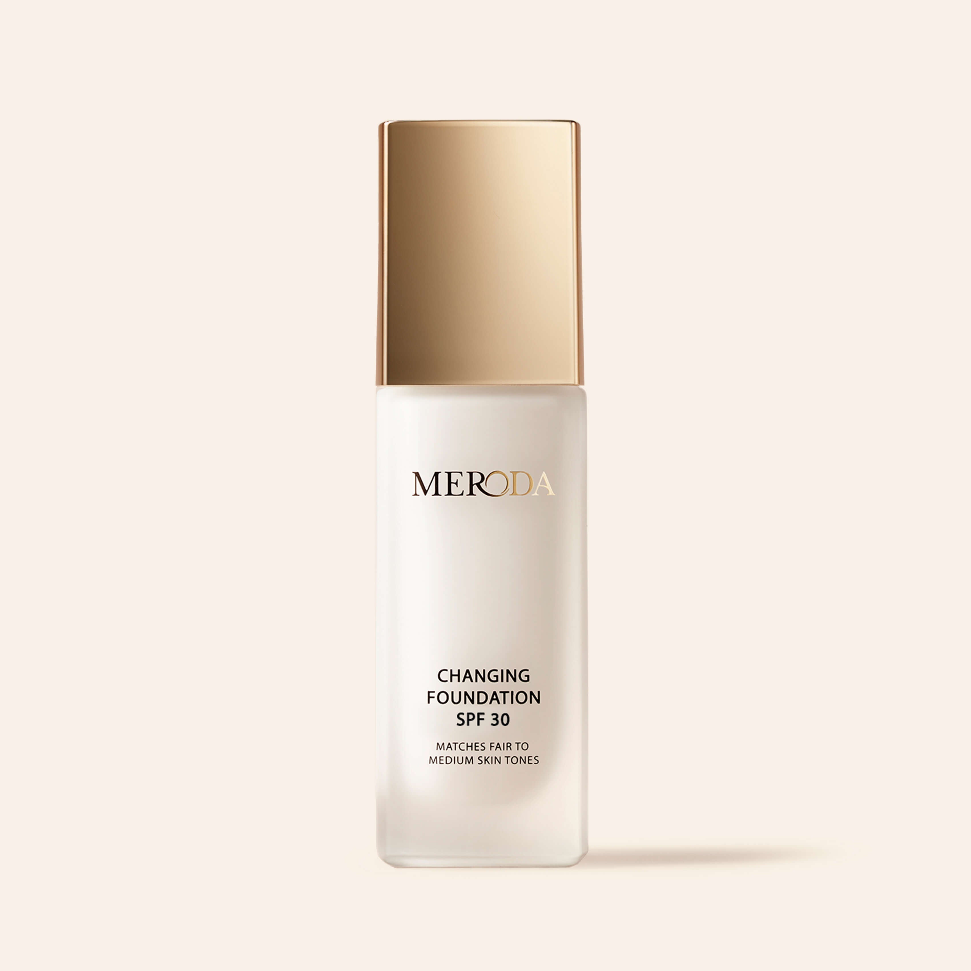 Meroda Changing Foundation SPF 30 in a frosted bottle with a gold cap for fair to medium skin tones.