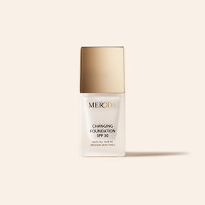 Mini Changing Foundation SPF 30 in a frosted bottle with a gold cap for fair to medium skin tones.