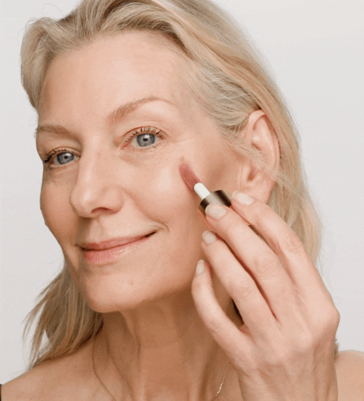 Vibrant Cheeks Liquid Blush in Dusty Rose being blended on a model’s cheeks for a soft, healthy glow.