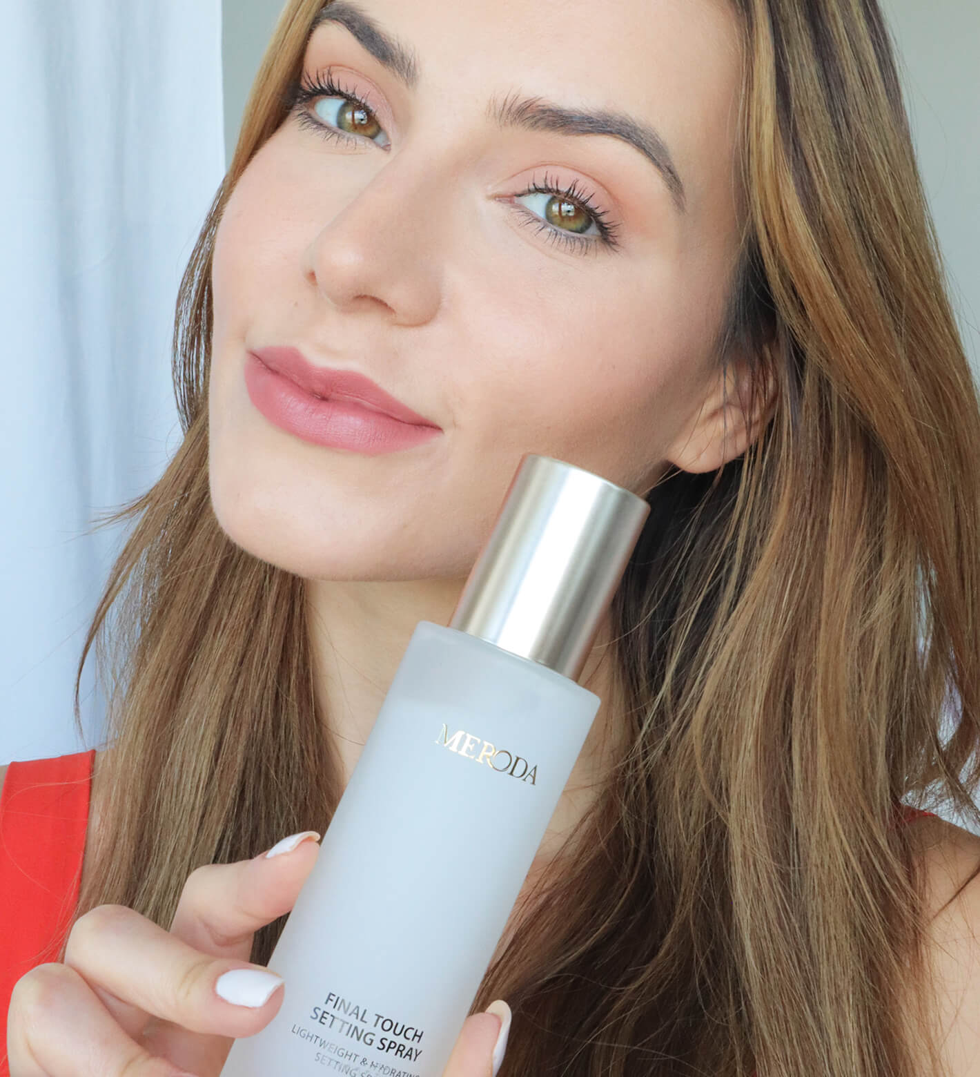Final Touch Setting Spray held by a model showcasing a fresh, radiant make-up look and luminous skin.