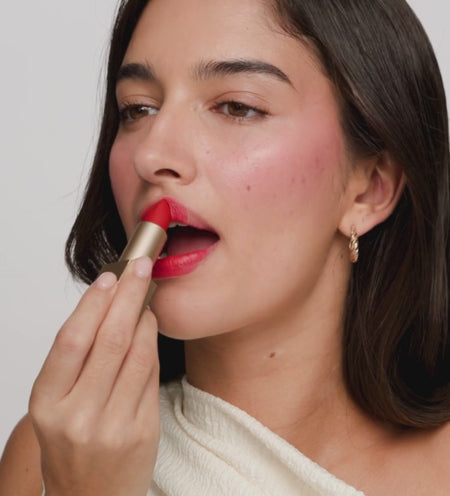 Applying the Luscious Red Velvet Dream Lipstick from the Luscious Lips Set for a bold matte finish.